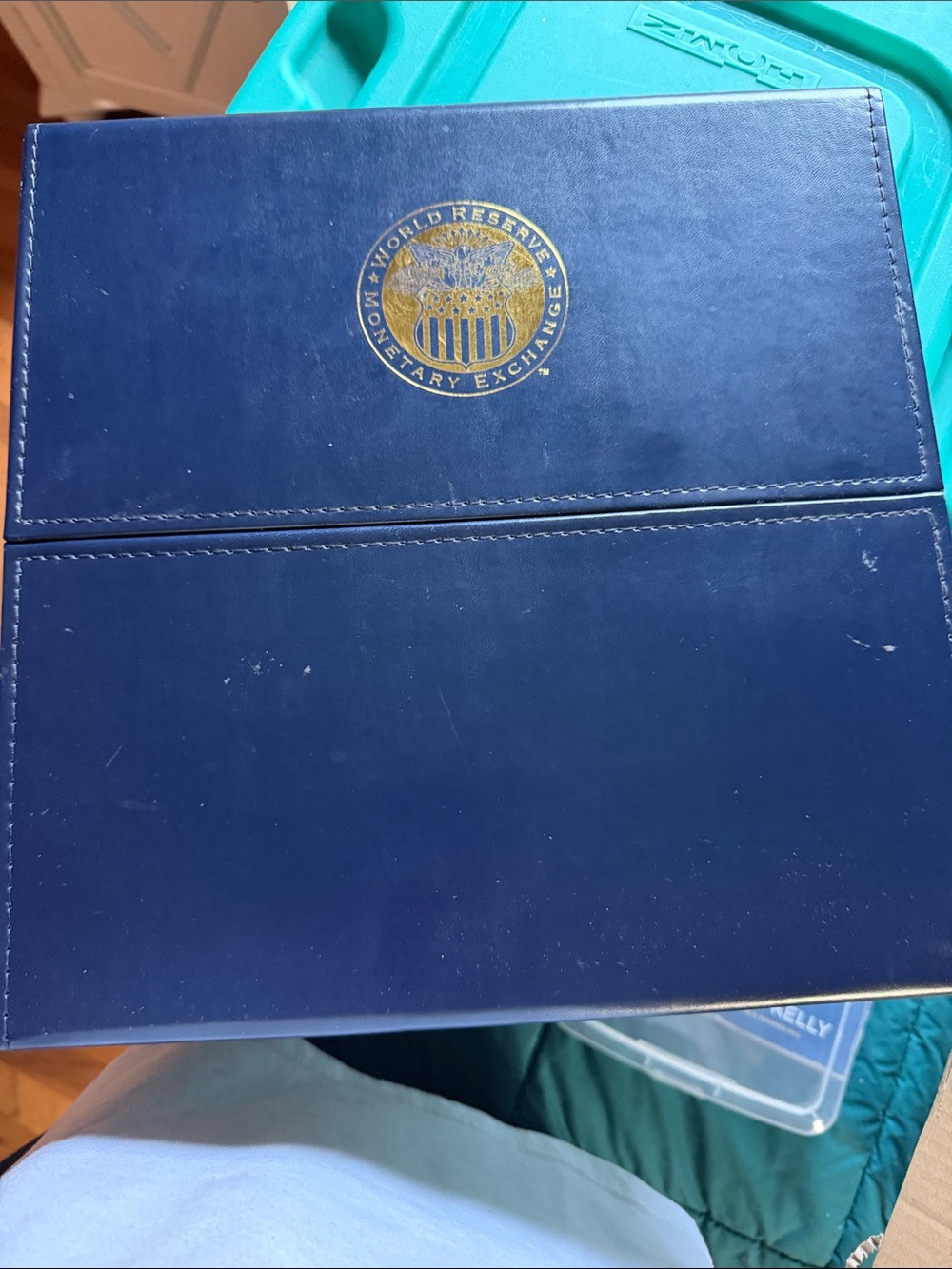 World Reserve Monetary Exchange Navy Folder with Gold Emblem
